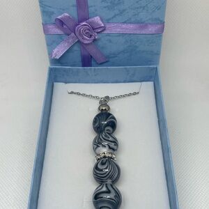 Exquisite Black & Silver Swirl Necklace
Expertly Handcrafted, Exclusively Yours